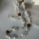 Présentation de détails d'un collier de perles d'ambre et de perles baroques