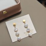 Pendientes colgantes de perlas naturales de agua dulce con detalles dorados